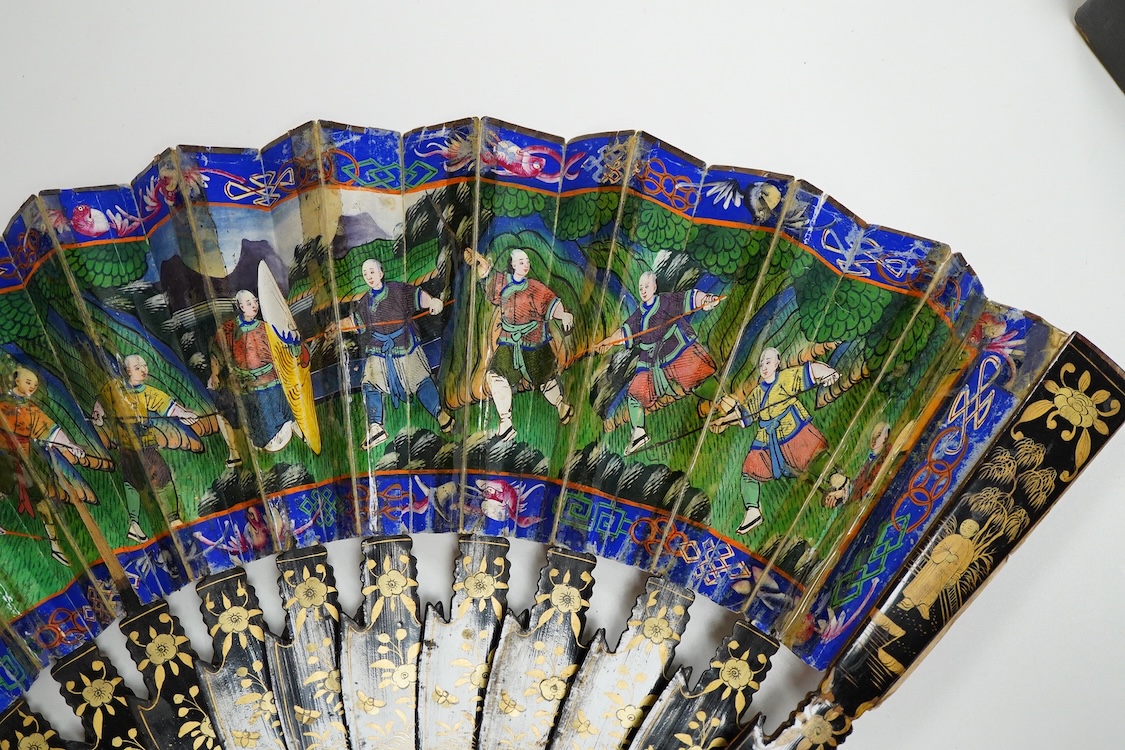 Four 19th century Chinese gilt-decorated black lacquer fans with figure painted leaves, two cased, largest 41cm